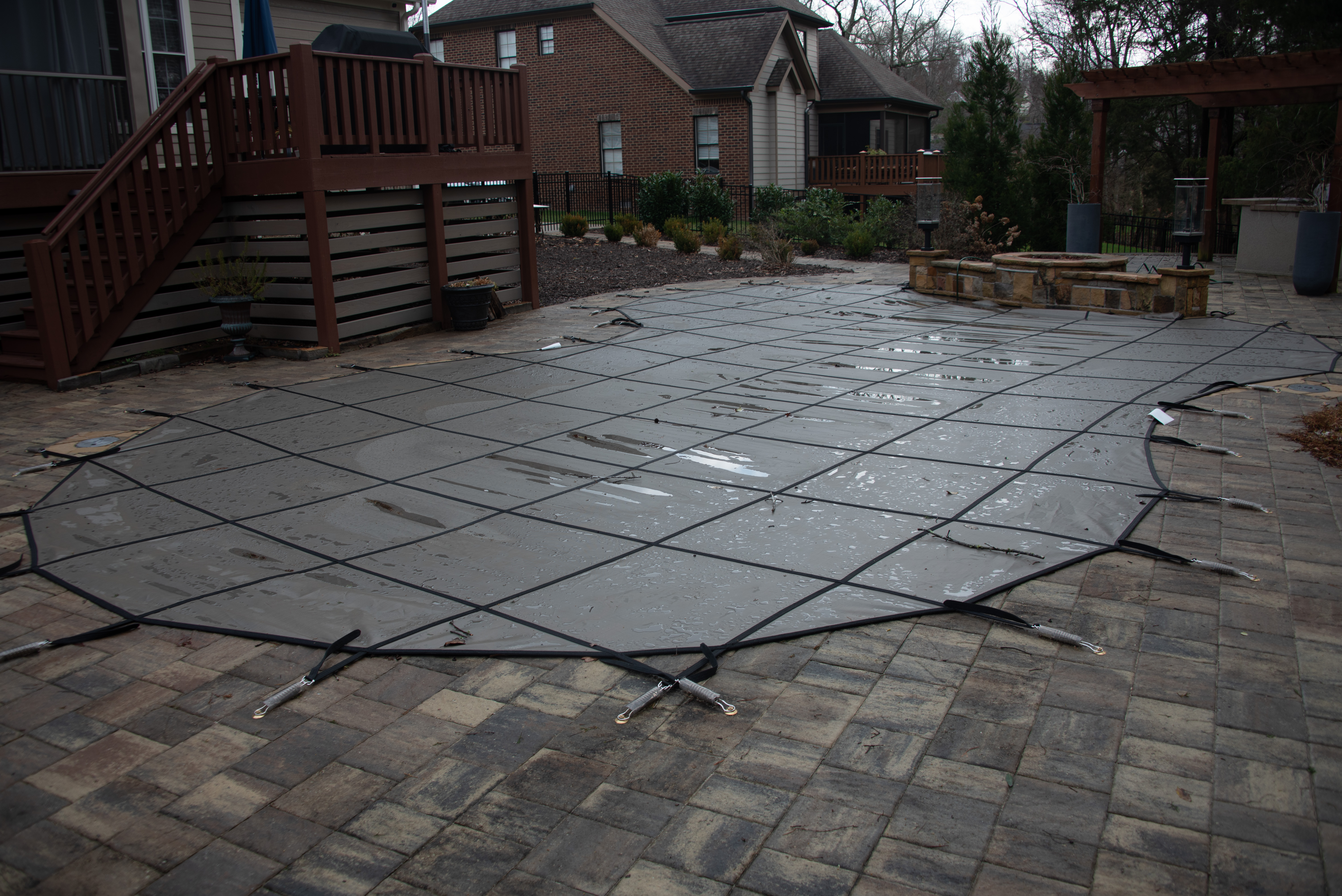 Safety cover installed over residential swimming pool